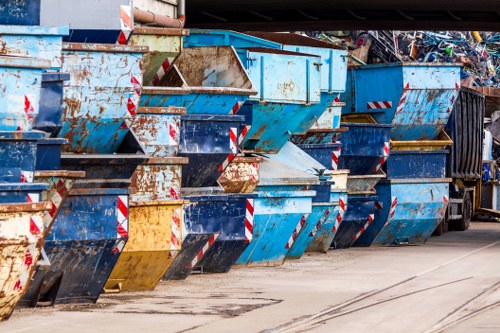Workers preparing commercial waste containers for removal